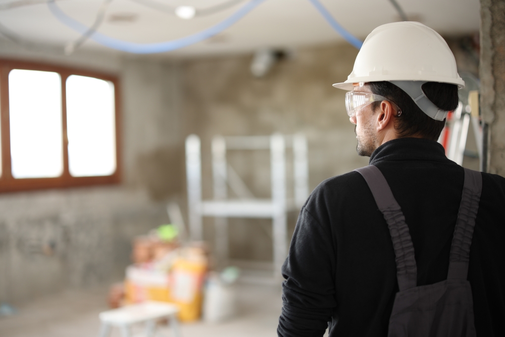 Back,View,Portrait,Of,A,Construction,Worker,Looking,At,Site
